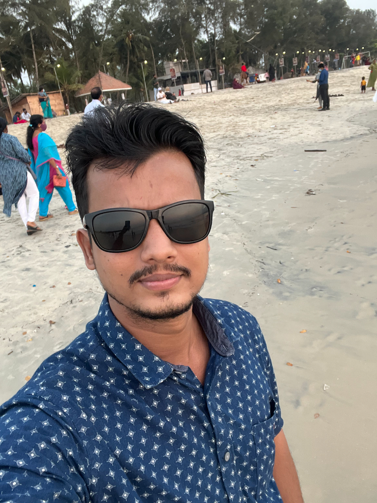 a man wearing sunglasses standing on a beach