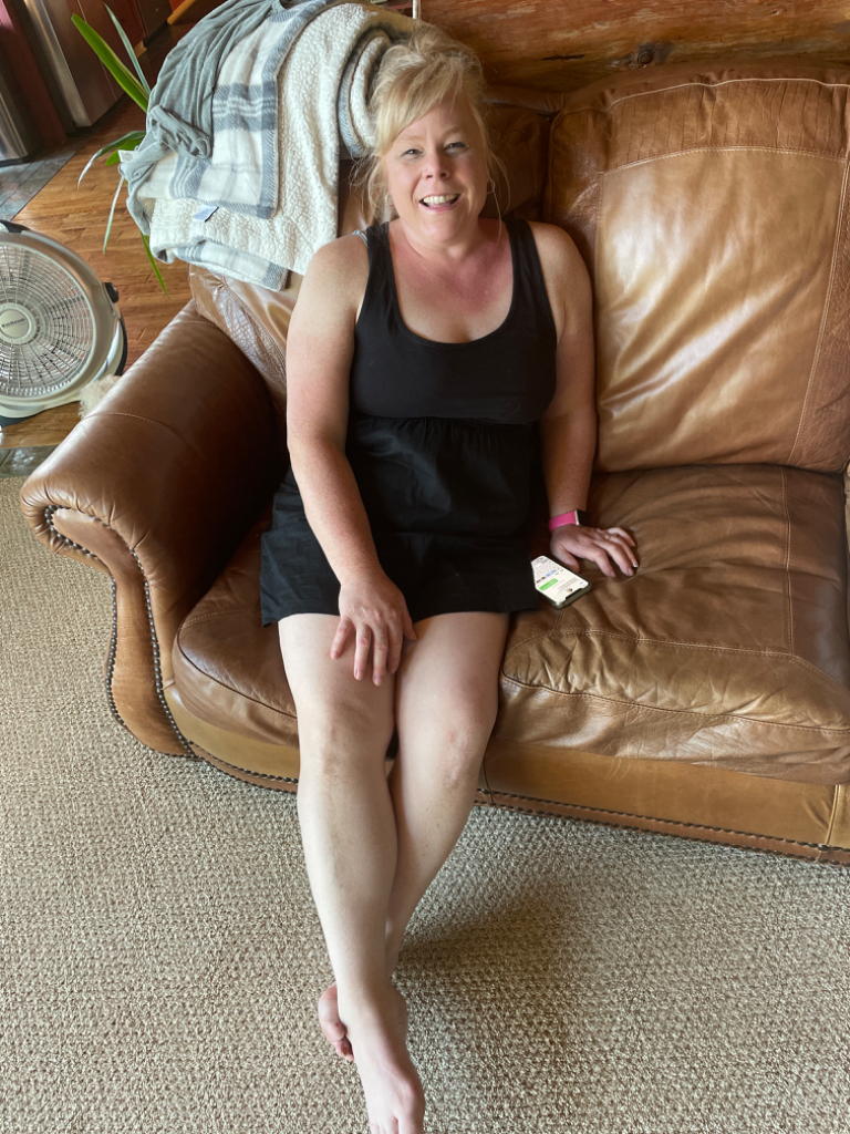 a woman sitting on a brown leather couch