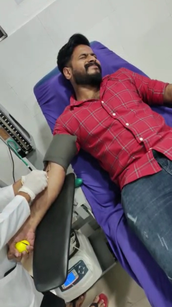 a man in a red shirt laying on a purple chair