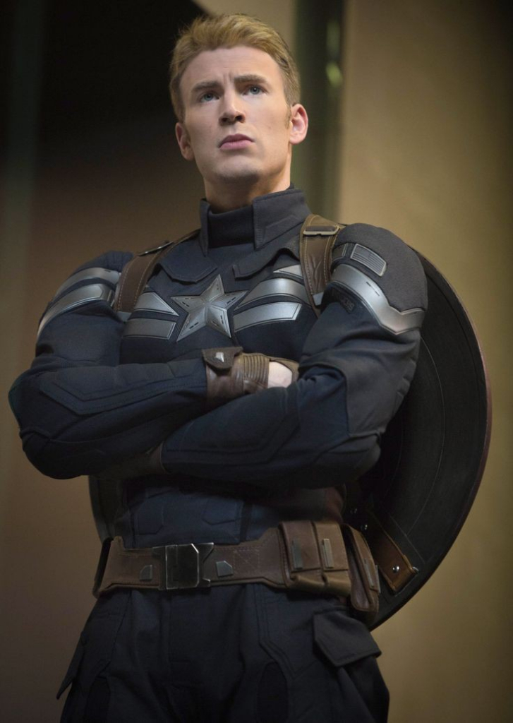 a man in a captain america costume standing with his arms crossed