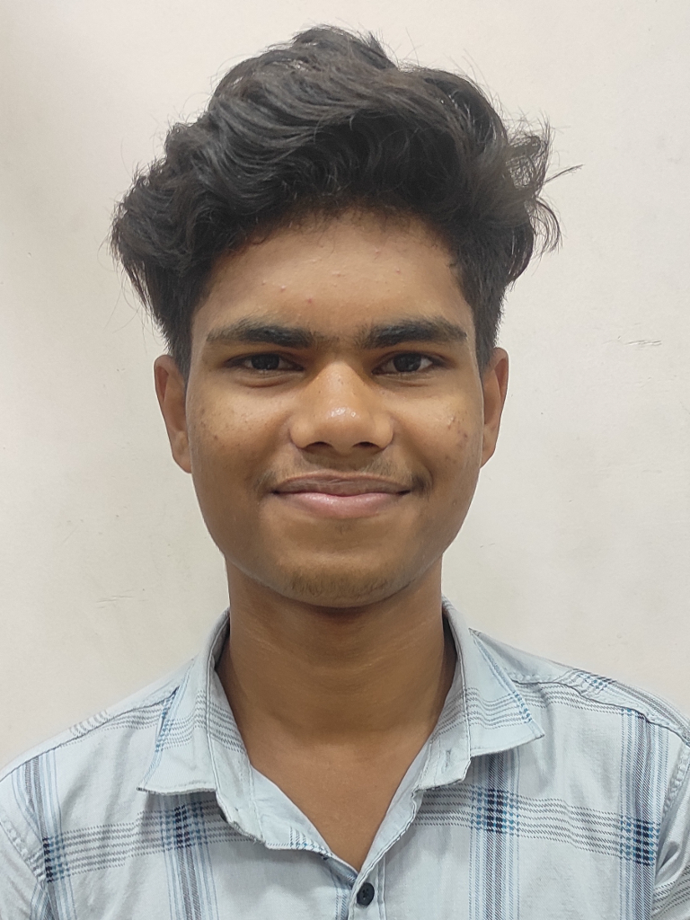 a man in a blue shirt smiling for the camera