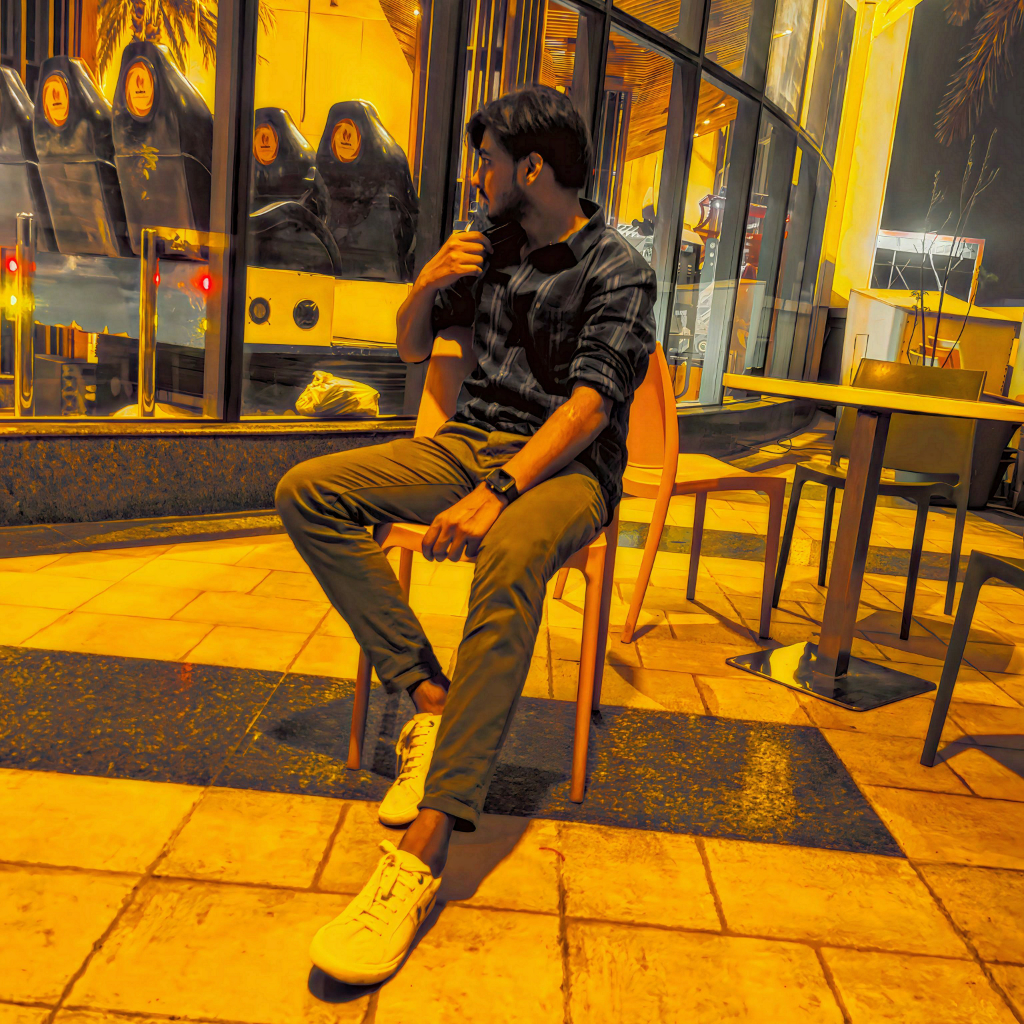 a man sitting on a chair in front of a building