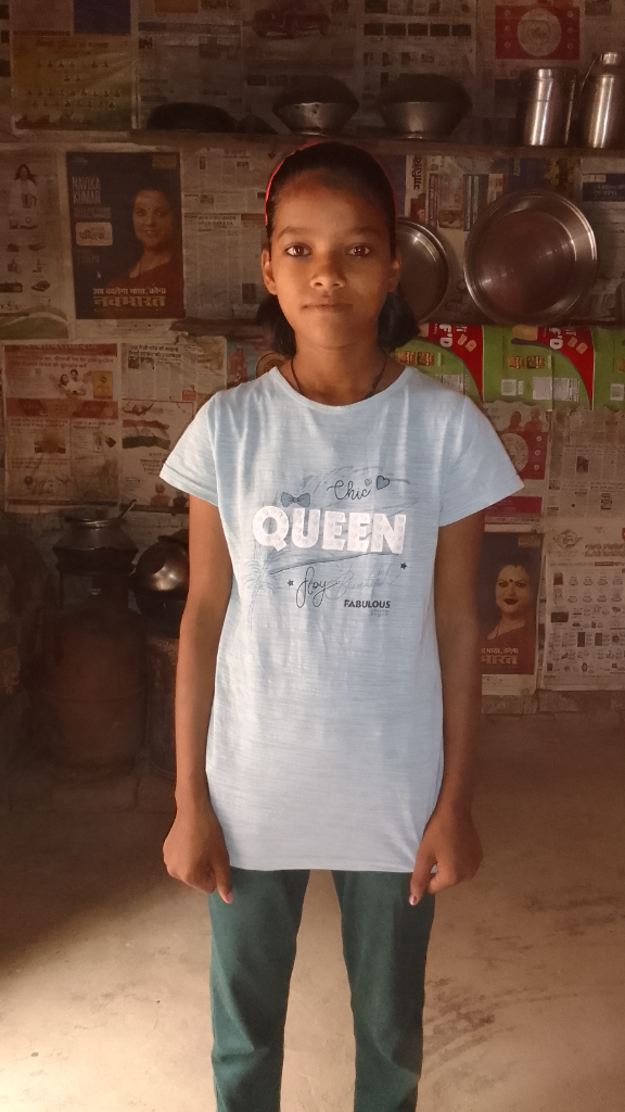 a young girl standing in front of a wall of newspapers