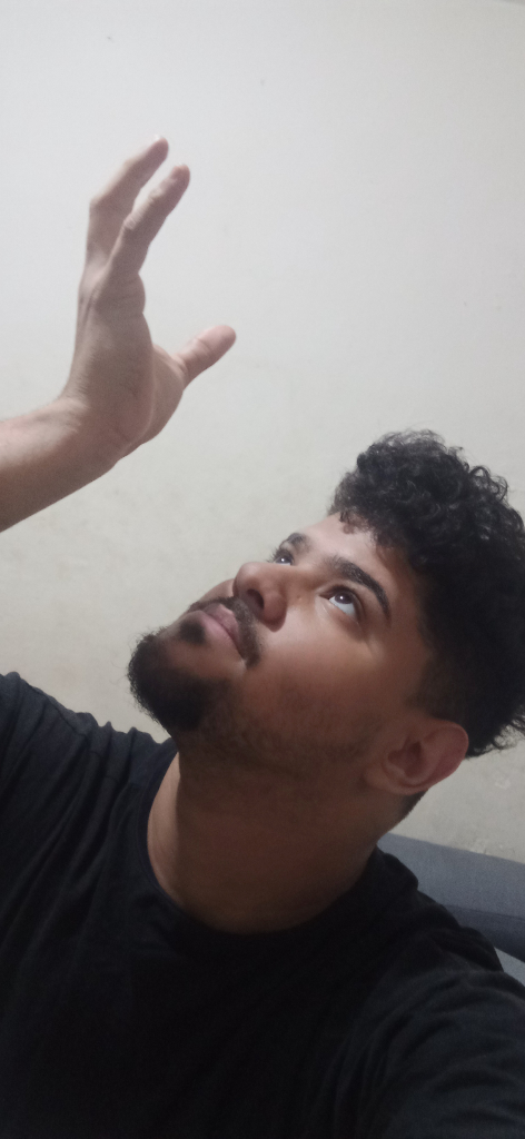 a man is holding his hand up in the air