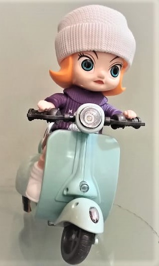 a doll is riding a toy scooter