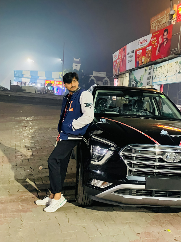 a man leaning on the hood of a car