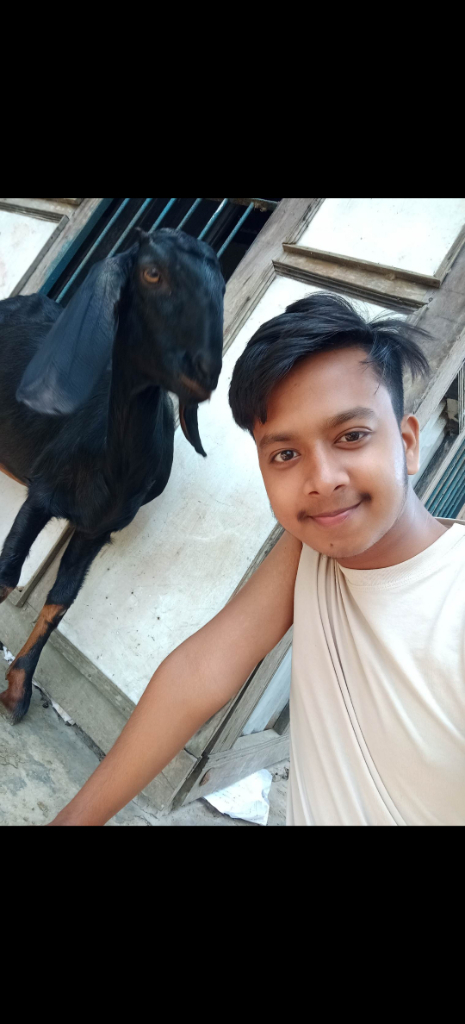 a man standing next to a statue of a goat