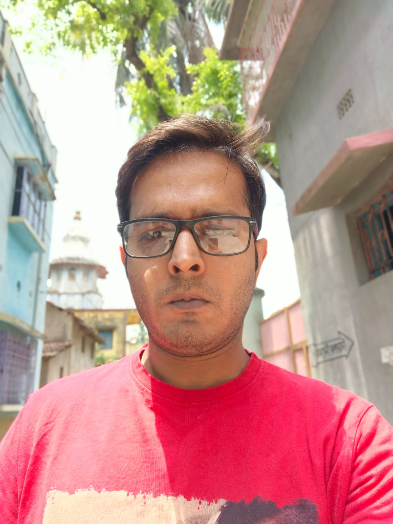 a man in a red shirt stands in front of a building, with a yellow shirt hanging off the building in an advertisement for a rival business. add a yellow shirt, and make it an advertisement for a rival business