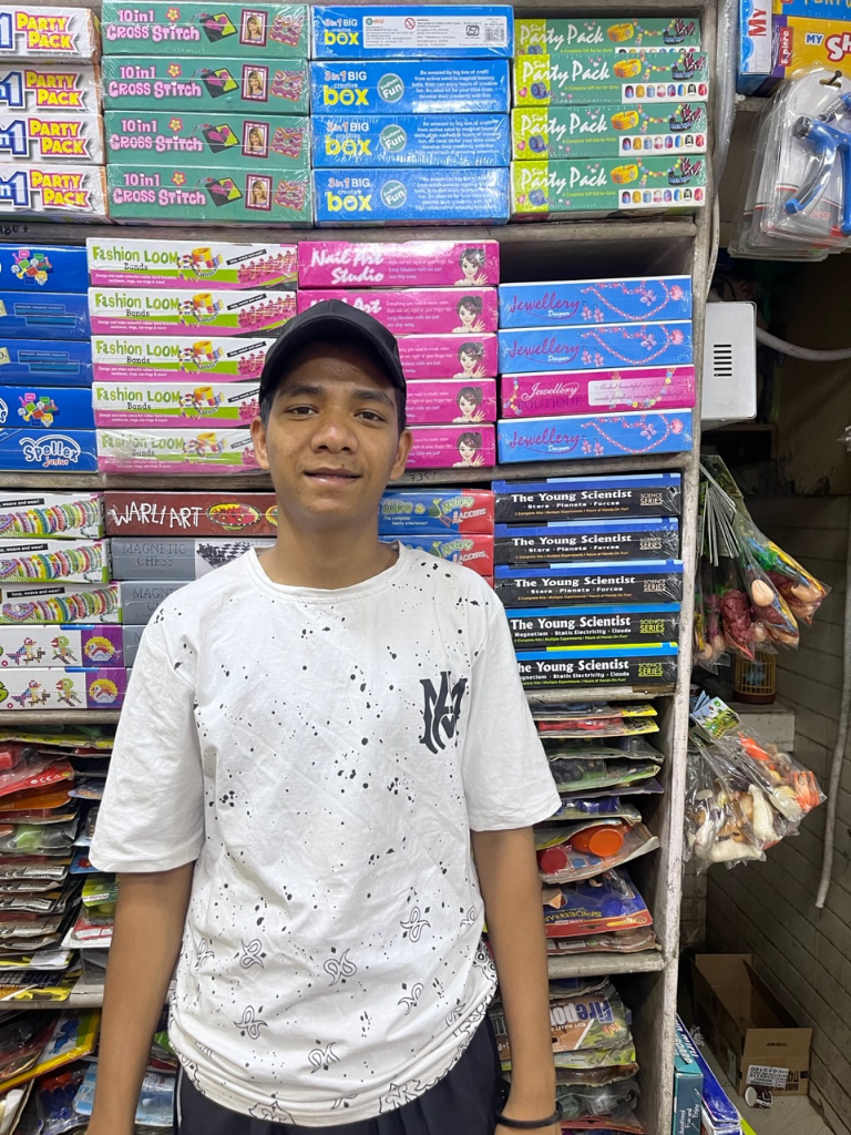 a young man standing in front of a store shelf. Make it into a painting, 8k