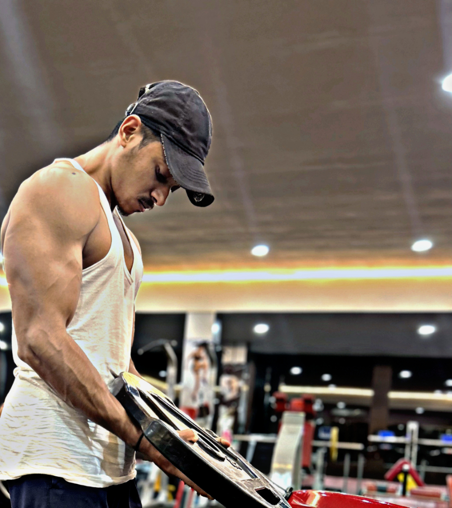 a man in a gym holding a gym bag