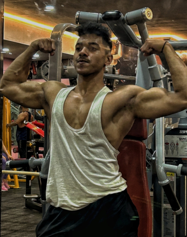 a man standing in front of a gym machine